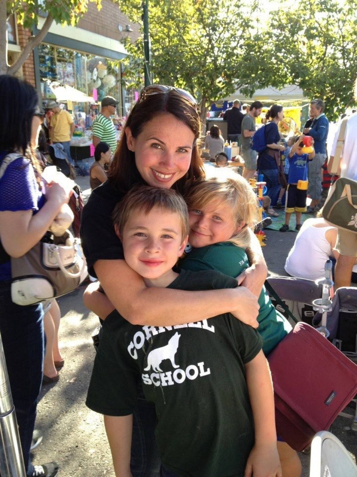 Stephanie Sala with two children at an outdoor fair